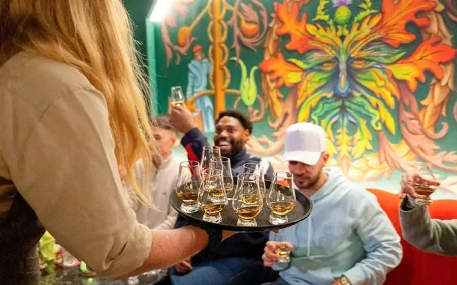 A flight of whisky glasses on a wooden table at a guided tasting